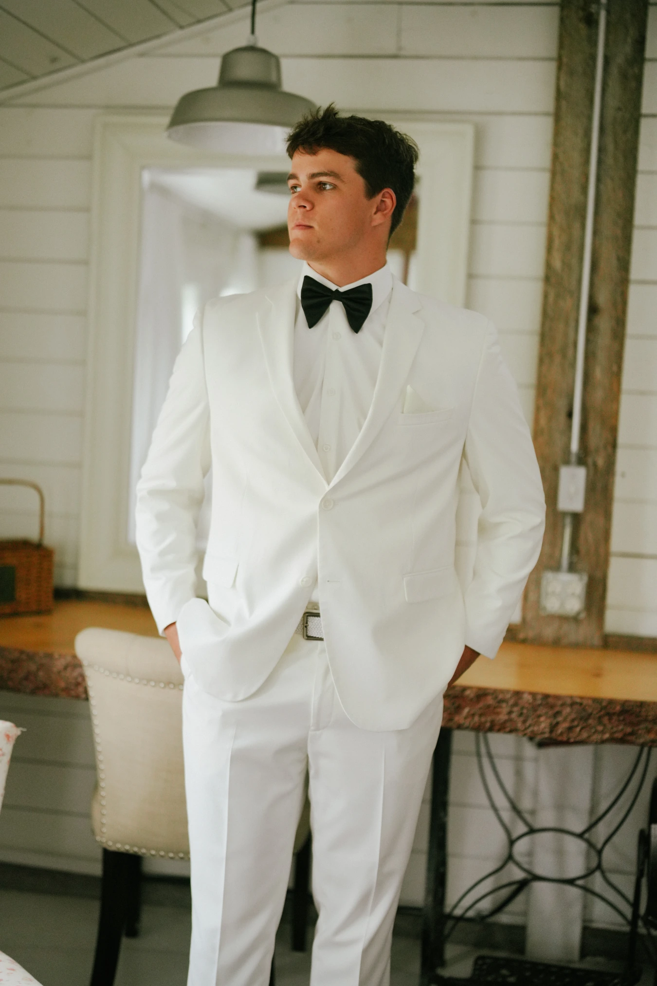 Teddy white tuxedo indoor portrait at Amy and Teddy's North Dakota farm wedding by Megaset Weddings