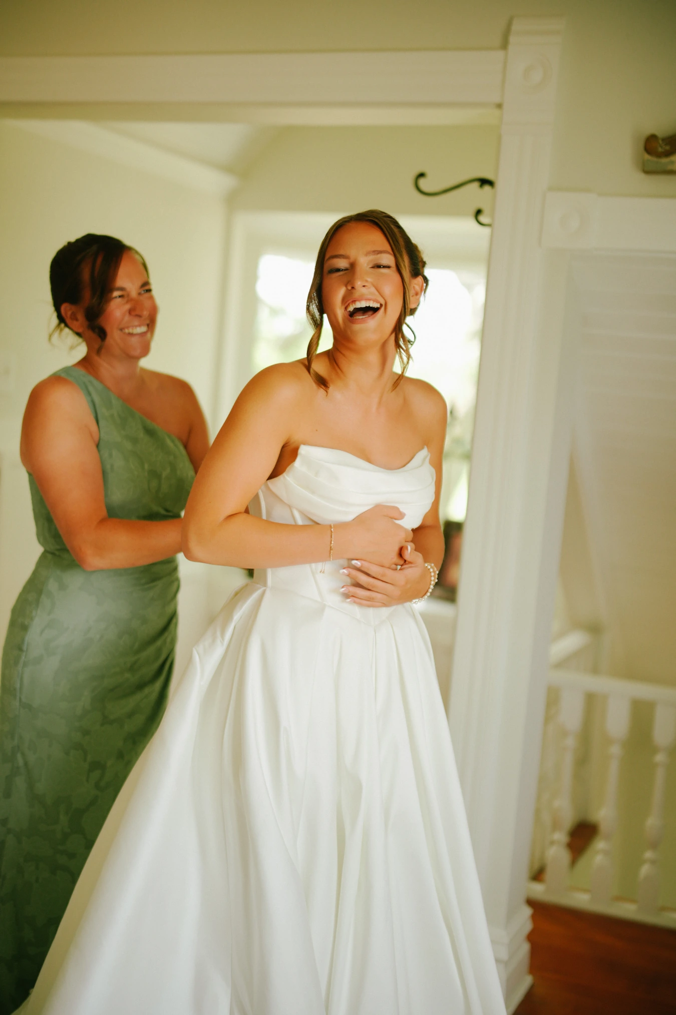 Amy maid of honor laughing at Amy and Teddy's North Dakota farm wedding by Megaset Weddings