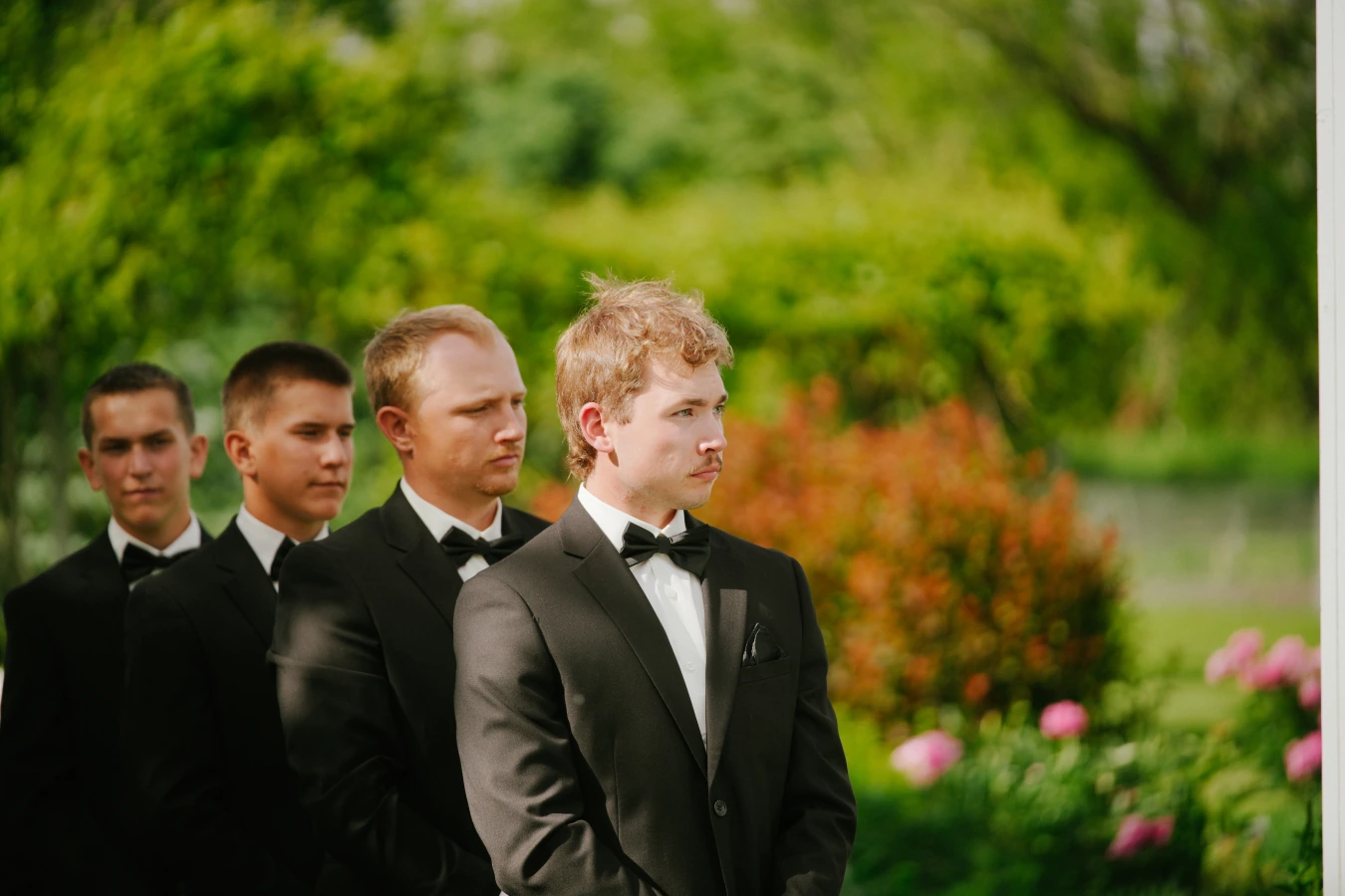 Teddysmen black suits outdoor at Amy and Teddy's North Dakota farm wedding by Megaset Weddings