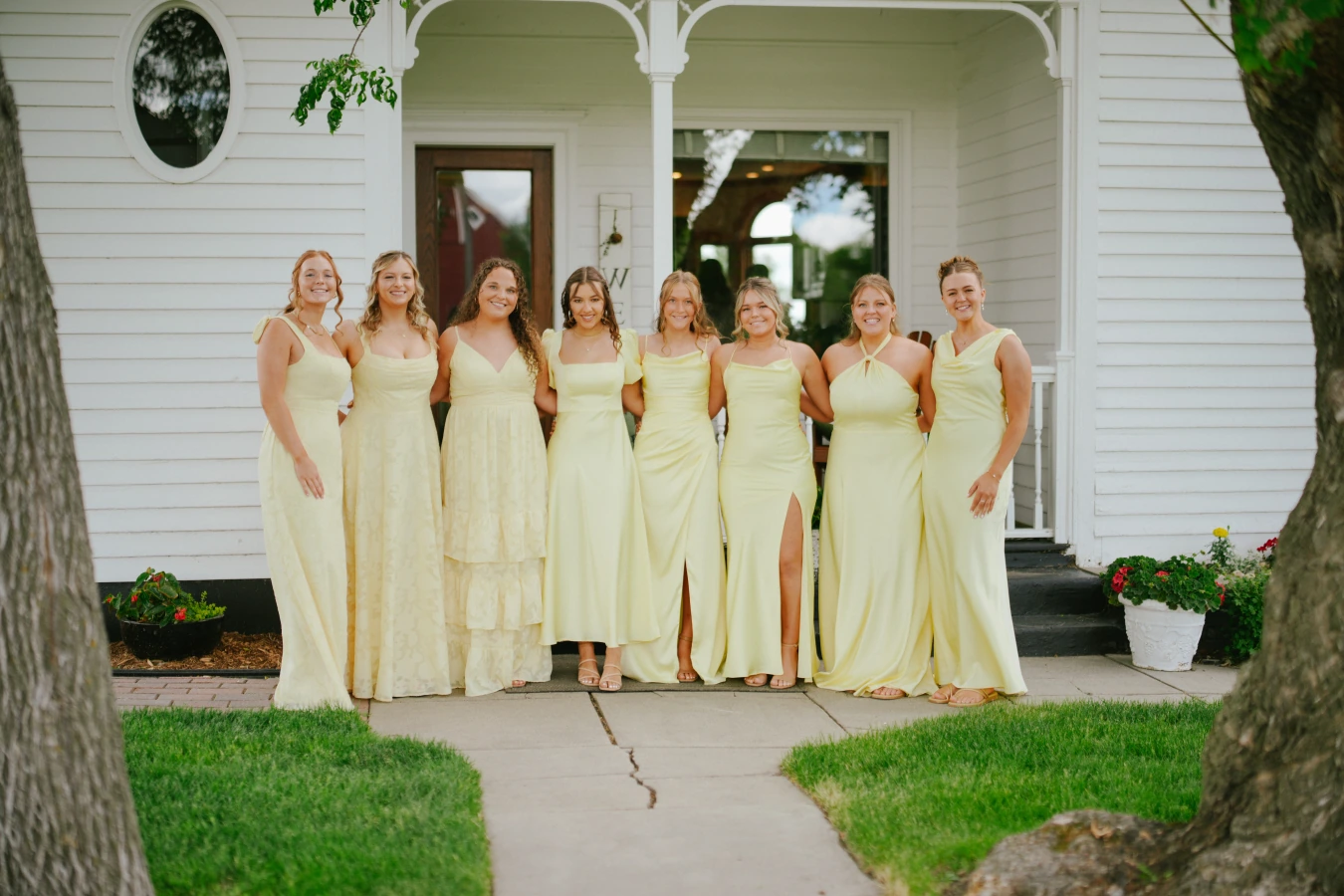 Amysmaids yellow dresses porch at Amy and Teddy's North Dakota farm wedding by Megaset Weddings