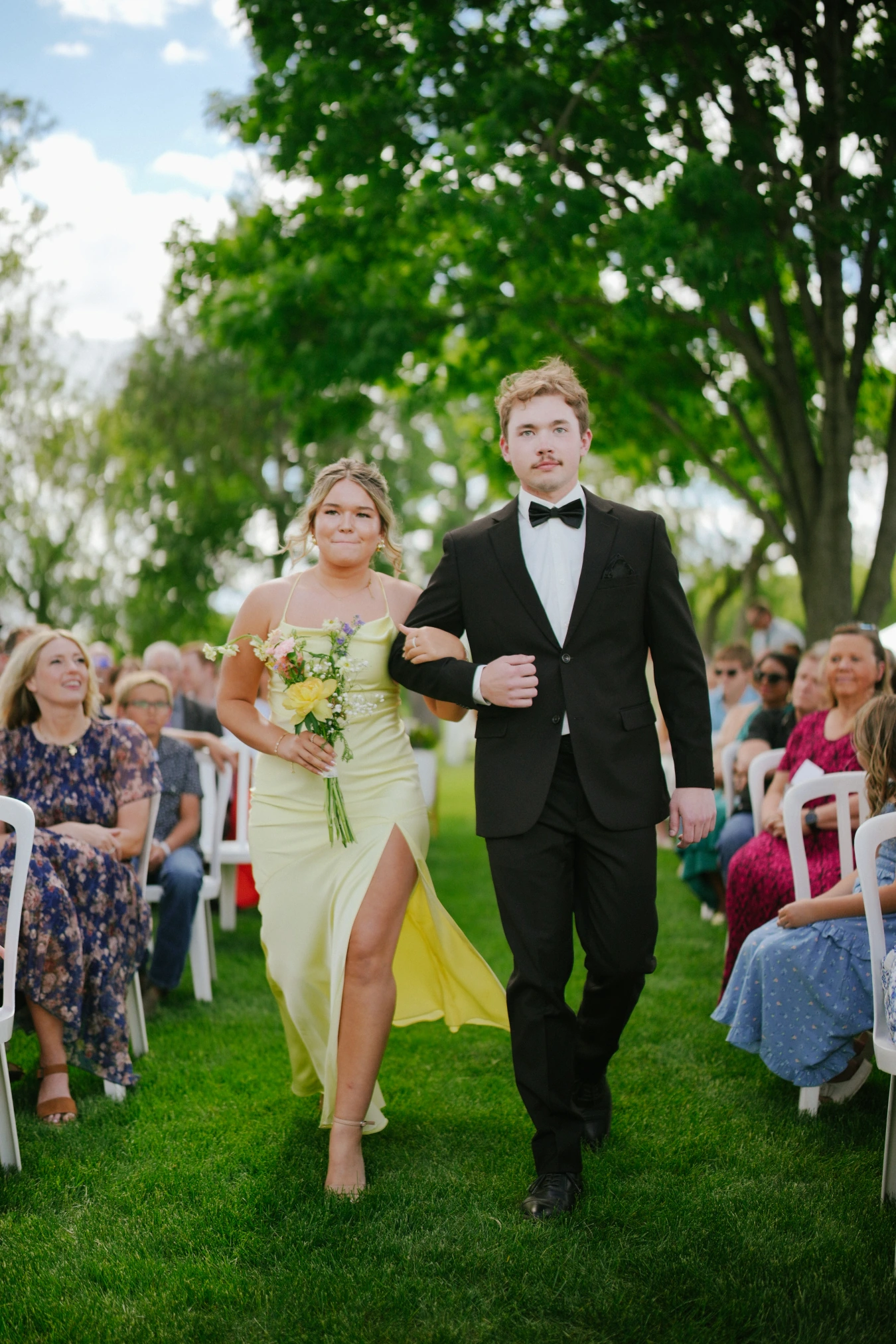 Amysmaid teddysman walking outdoor aisle at Amy and Teddy's North Dakota farm wedding by Megaset Weddings