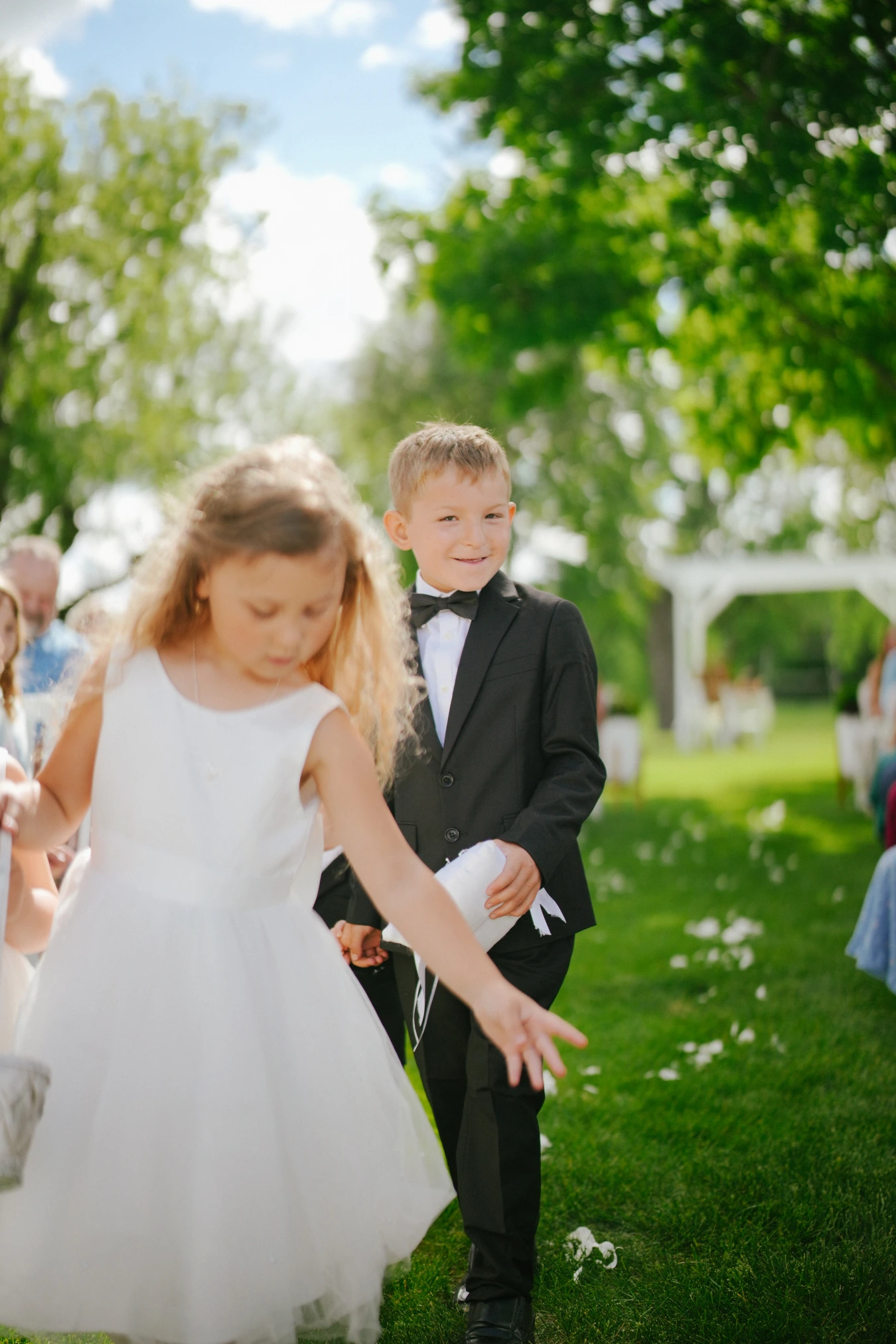 Children formal attire outdoors at Amy and Teddy's North Dakota farm wedding by Megaset Weddings