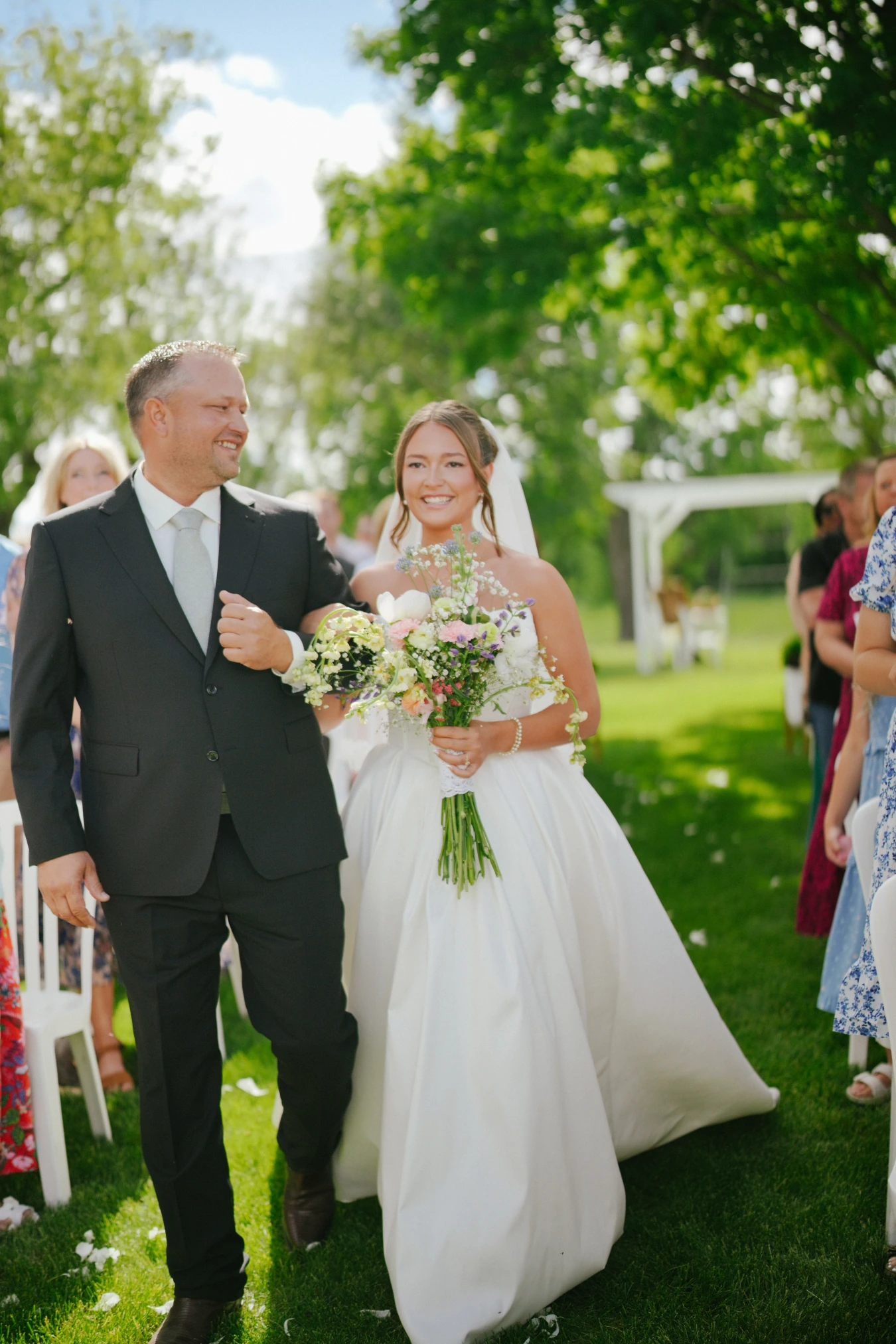 Amy father walking outdoor wedding aisle at Amy and Teddy's North Dakota farm wedding by Megaset Weddings