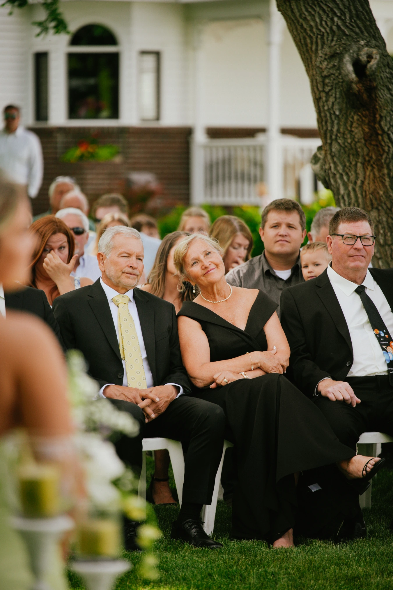 Ceremony guests seated outdoors at Amy and Teddy's North Dakota farm wedding by Megaset Weddings