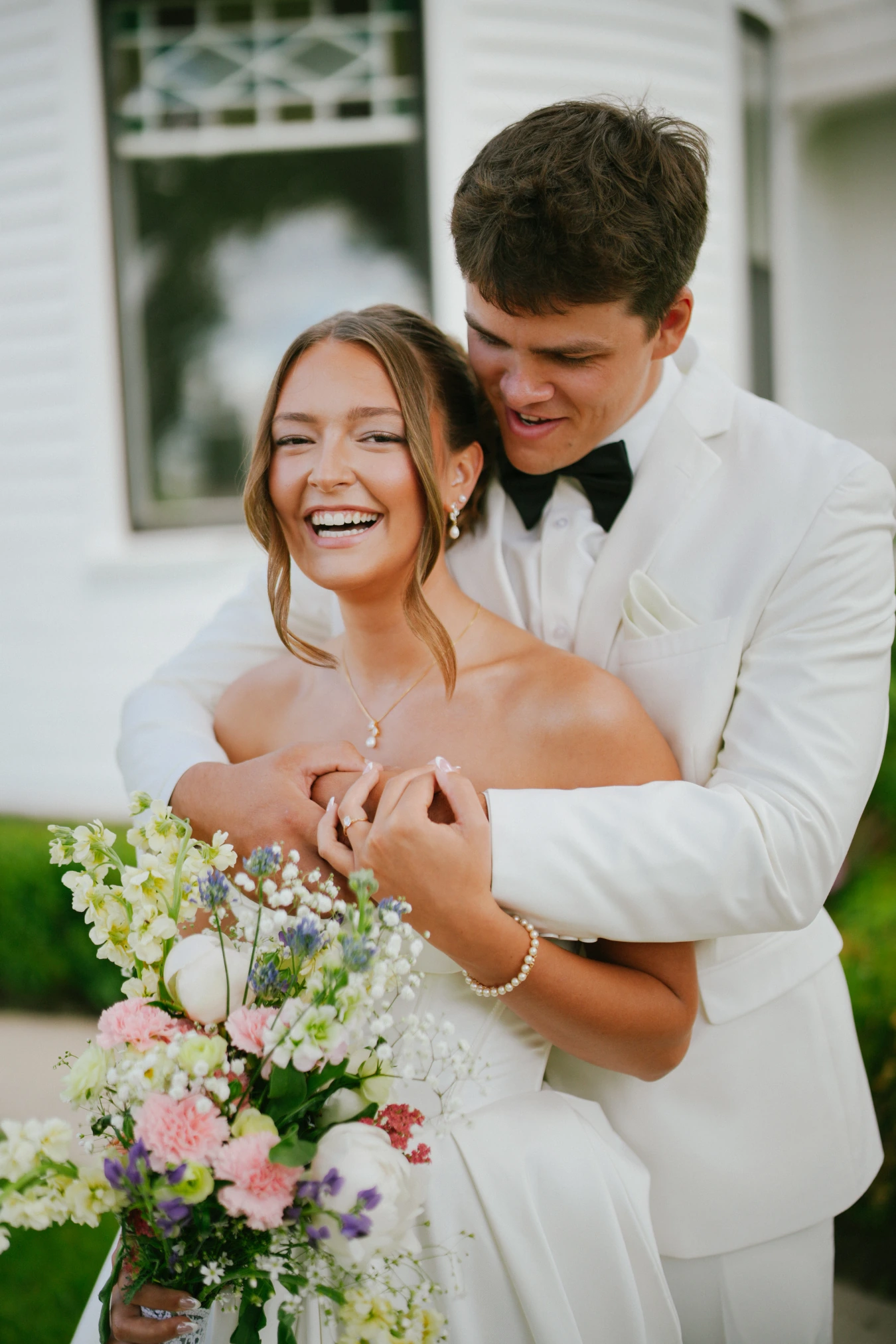 Amy and teddy embrace bouquet portrait at Amy and Teddy's North Dakota farm wedding by Megaset Weddings