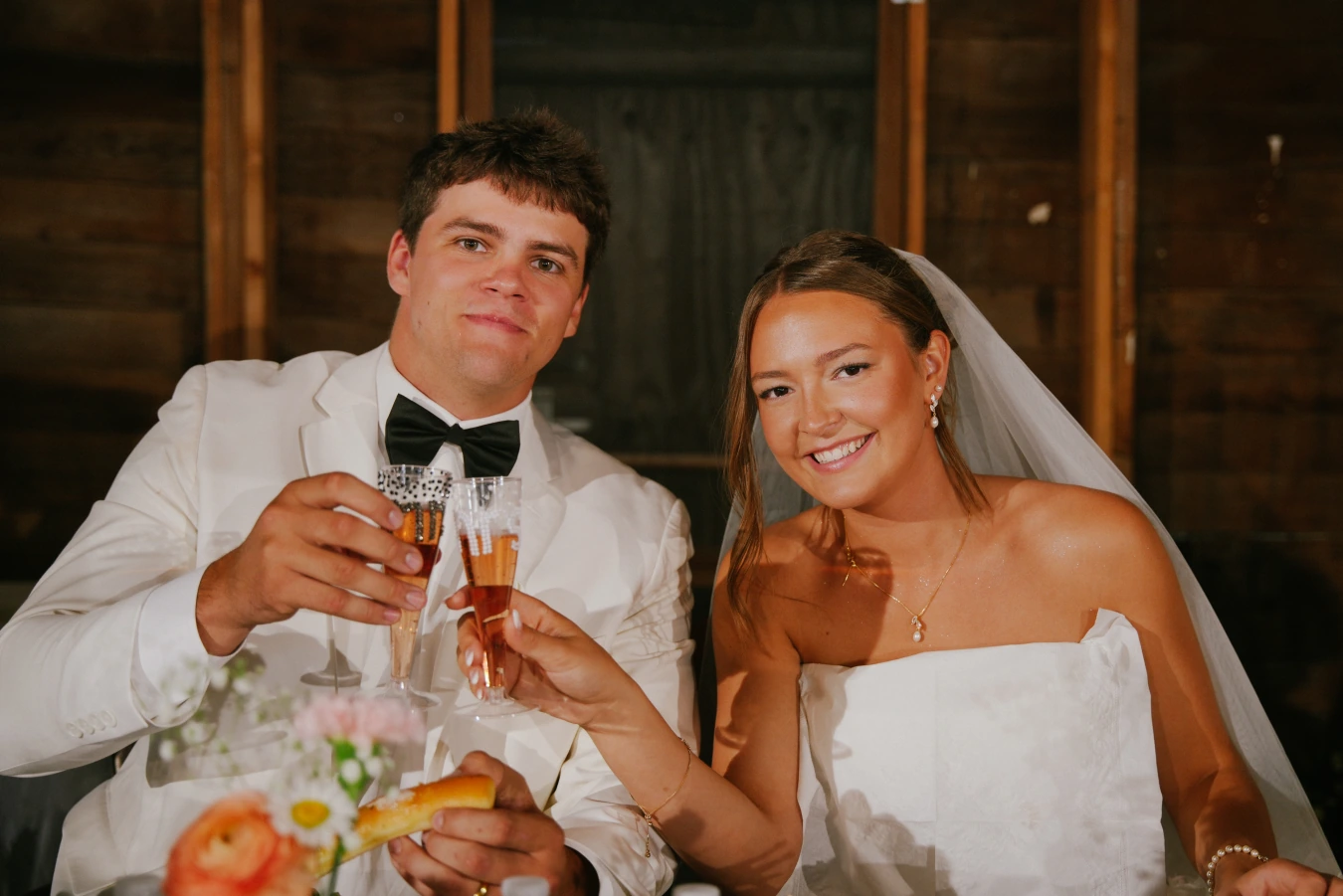 Amy and teddy reception toasting at Amy and Teddy's North Dakota farm wedding by Megaset Weddings
