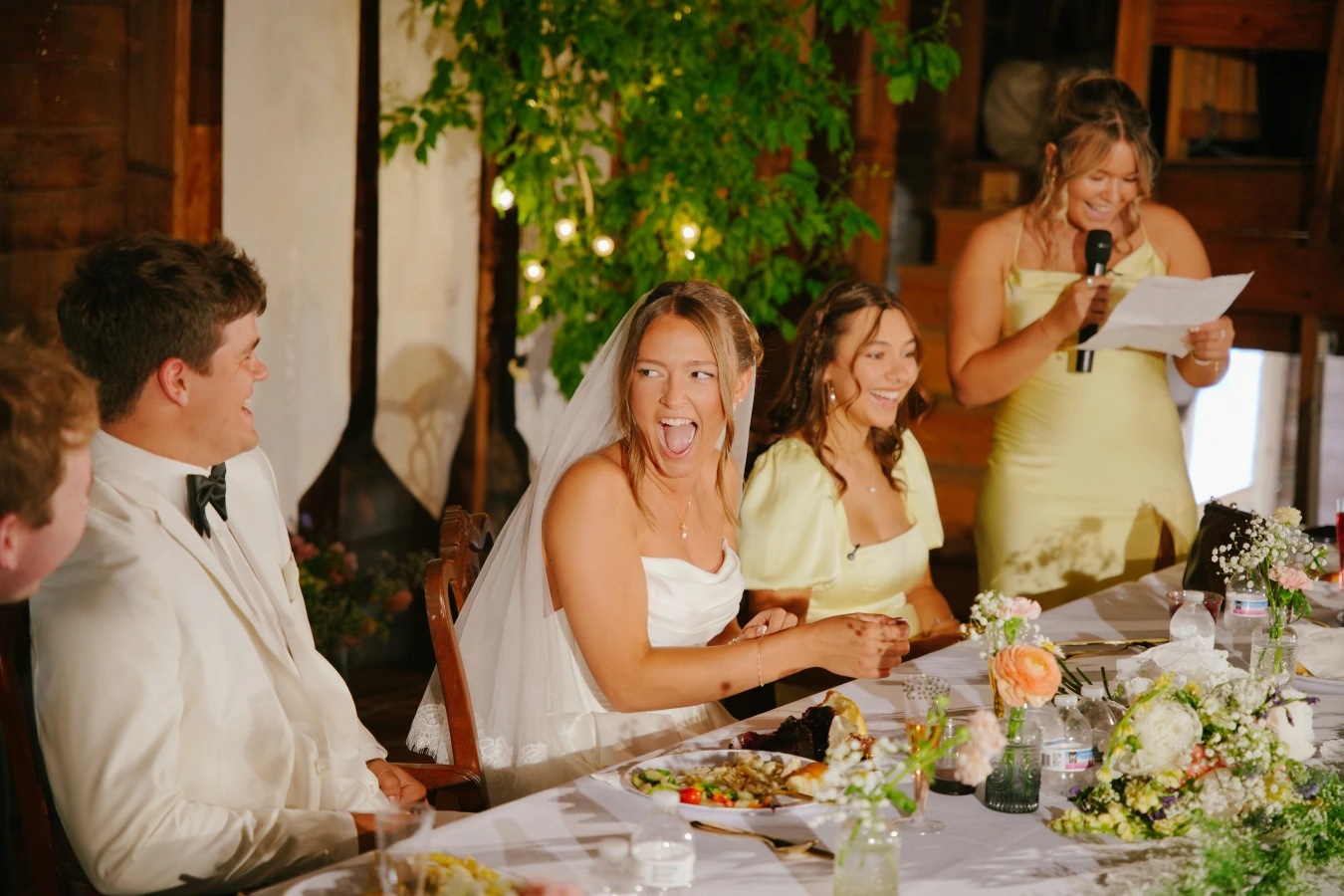 Amy reception laughing guests decor at Amy and Teddy's North Dakota farm wedding by Megaset Weddings