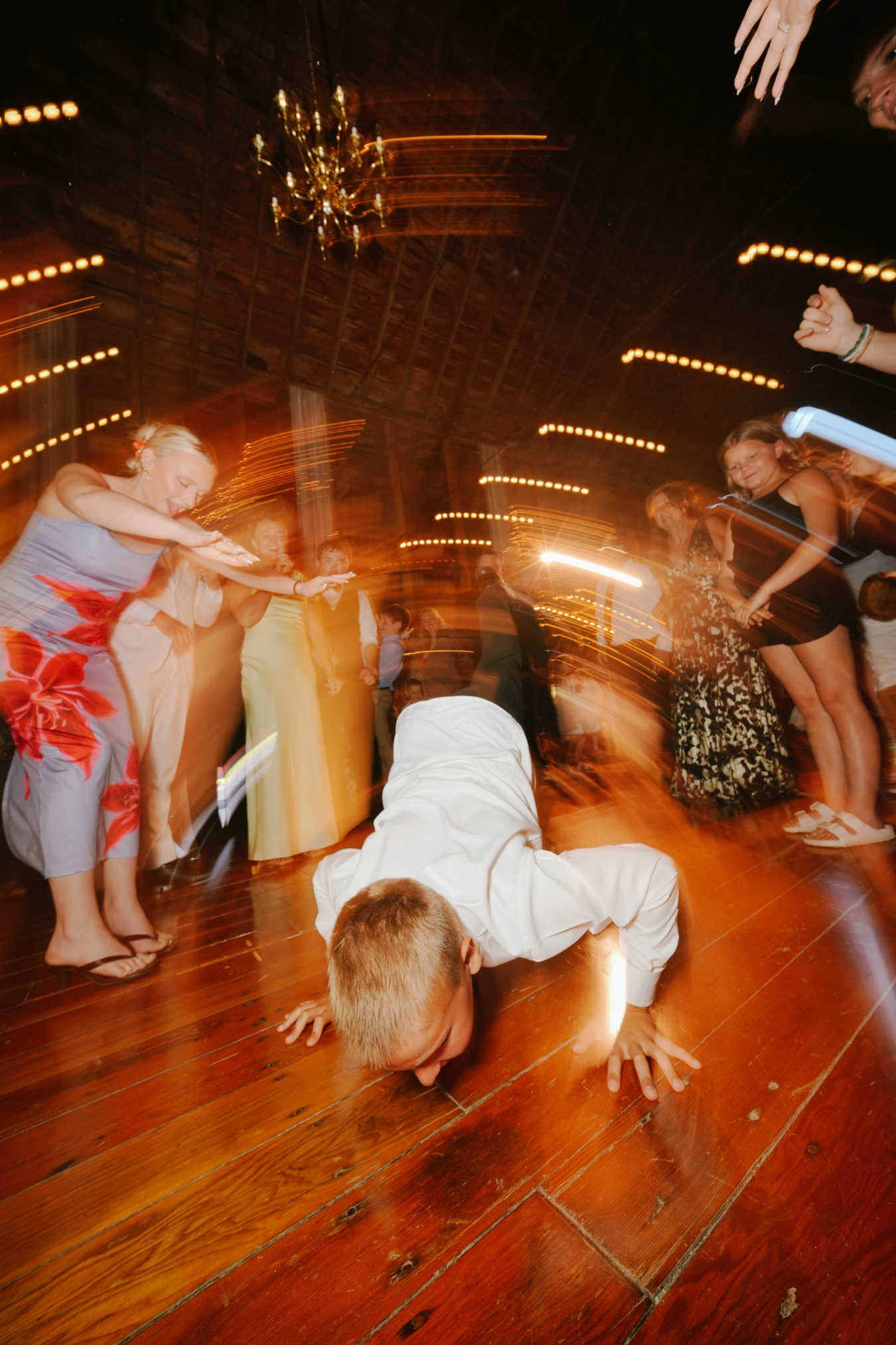 Reception boy crawling floor guests at Amy and Teddy's North Dakota farm wedding by Megaset Weddings