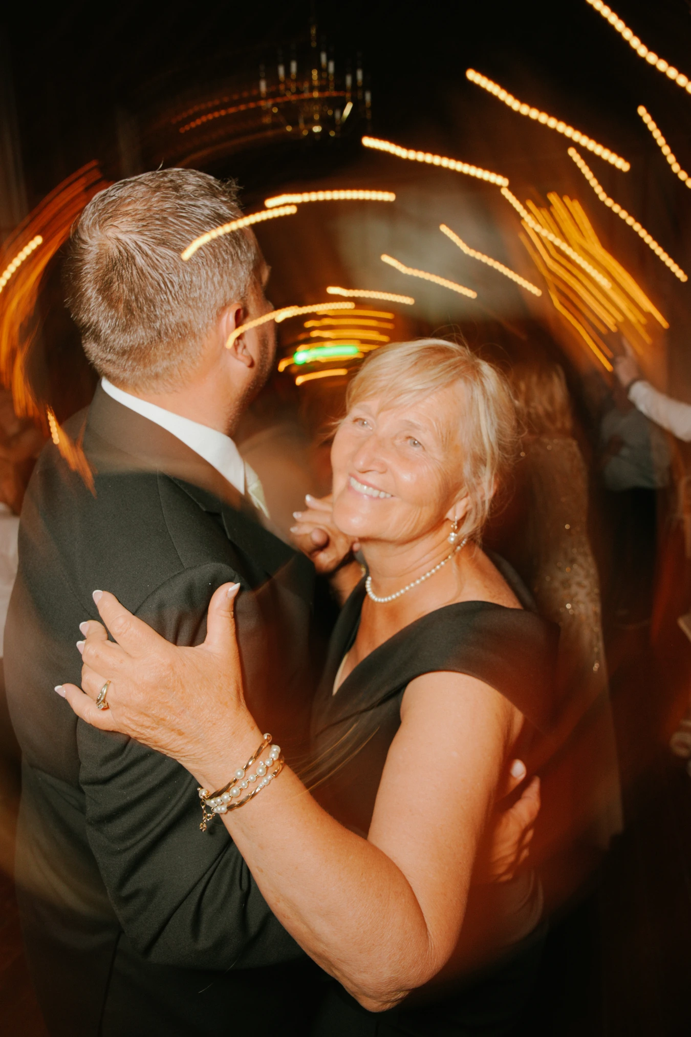 Elderly couple dance light trails at Amy and Teddy's North Dakota farm wedding by Megaset Weddings