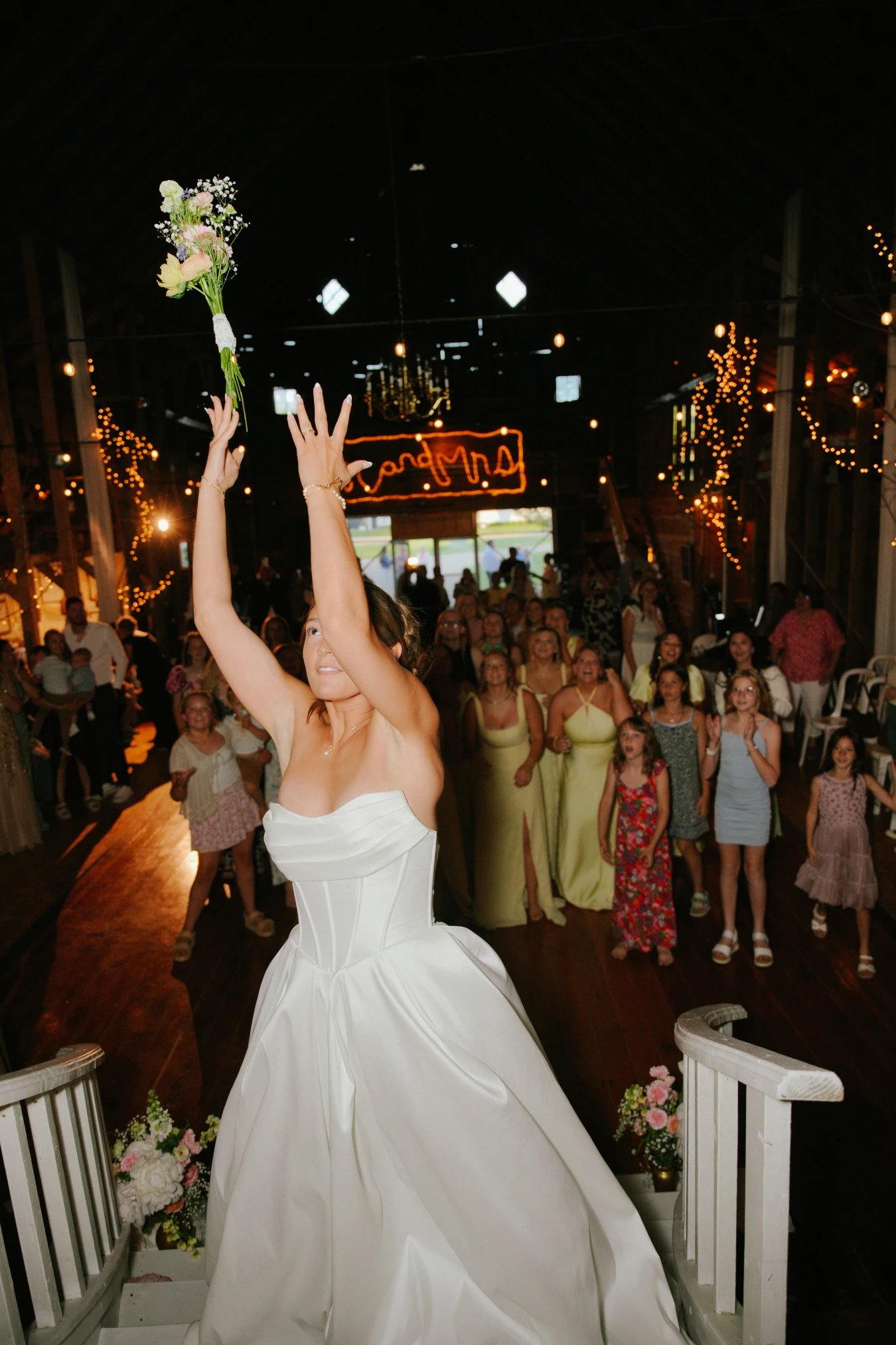 Amy tossing bouquet reception at Amy and Teddy's North Dakota farm wedding by Megaset Weddings