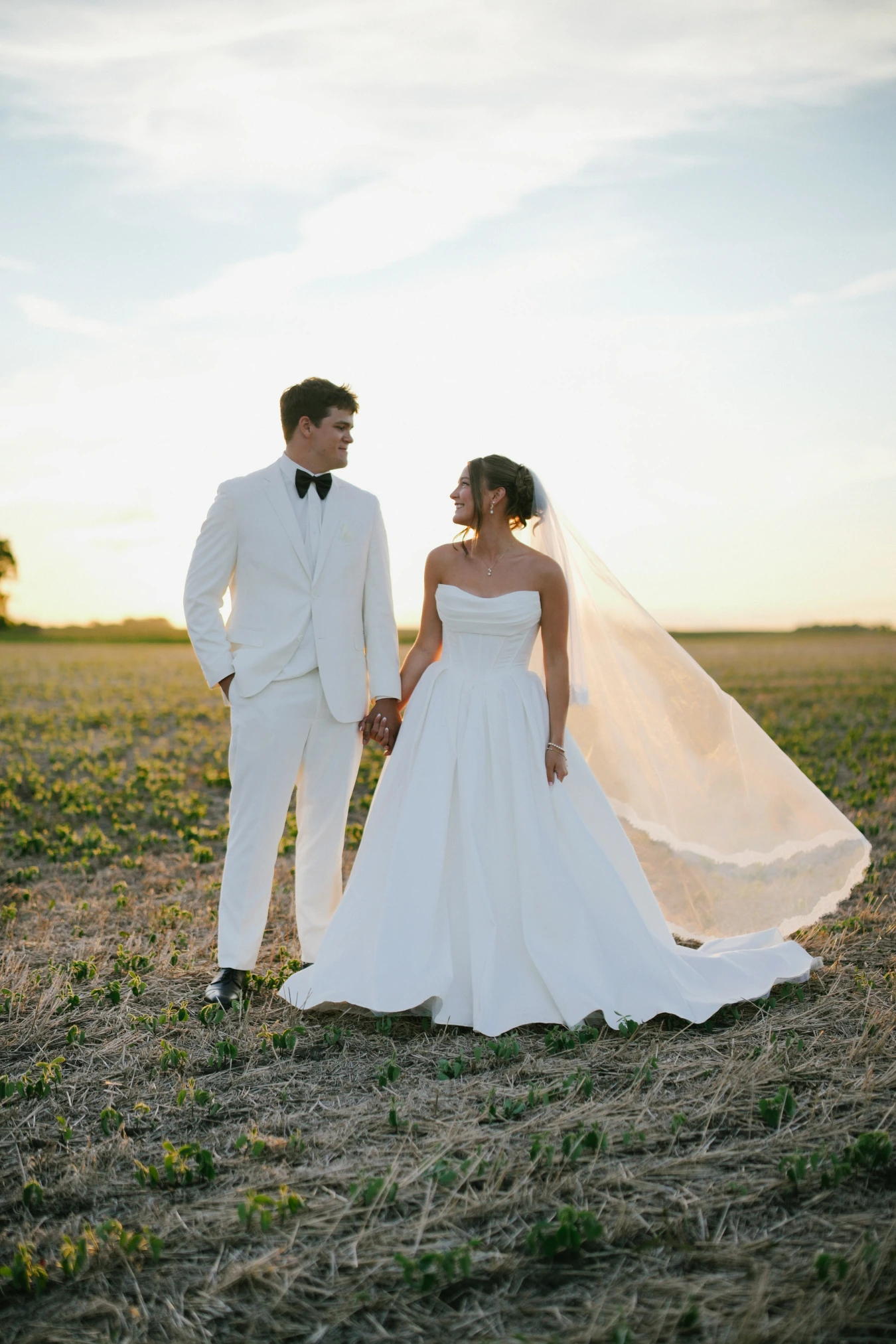 Amy and teddy field sunset portrait at Amy and Teddy's North Dakota farm wedding by Megaset Weddings