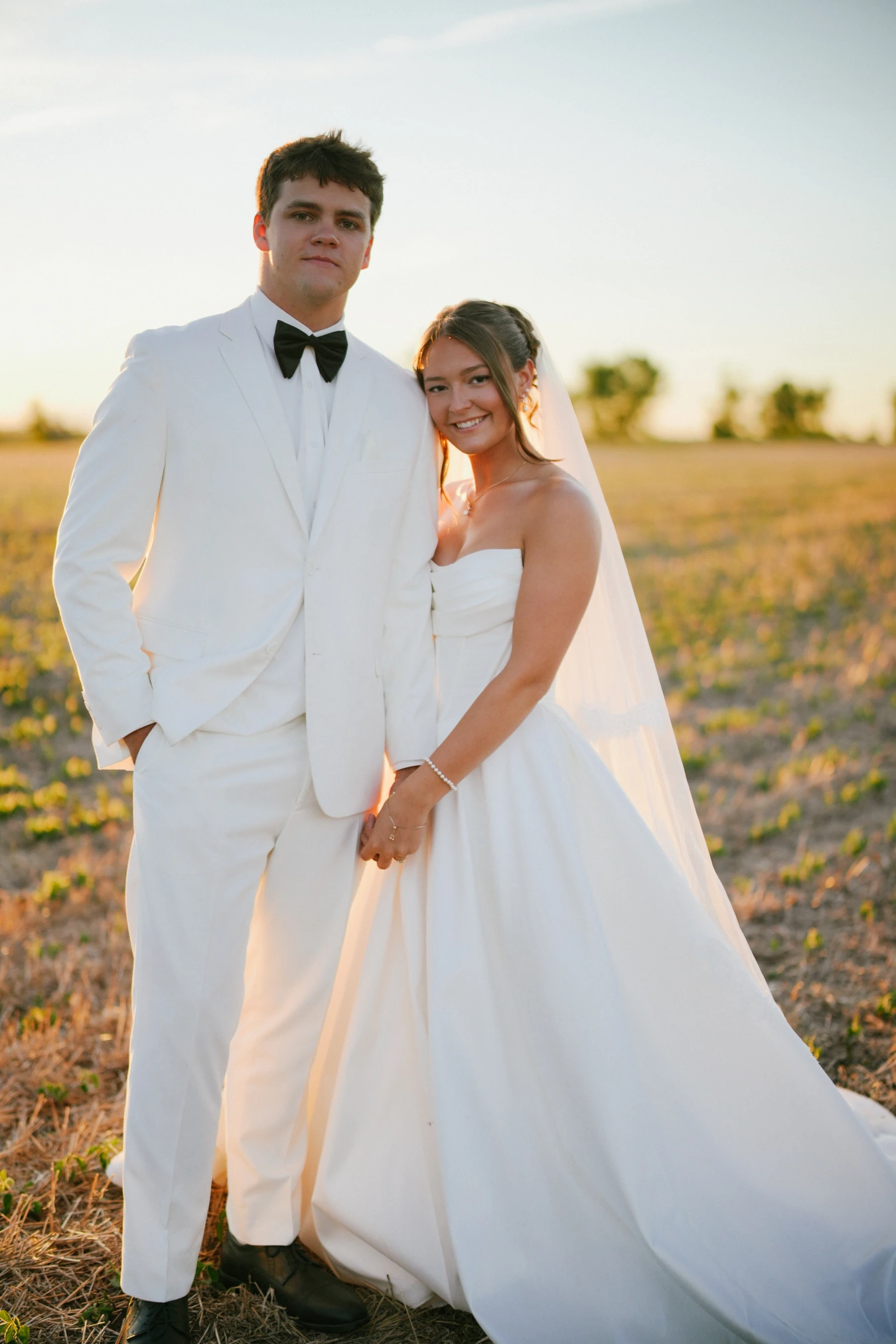 Amy and teddy white sunset portrait at Amy and Teddy's North Dakota farm wedding by Megaset Weddings