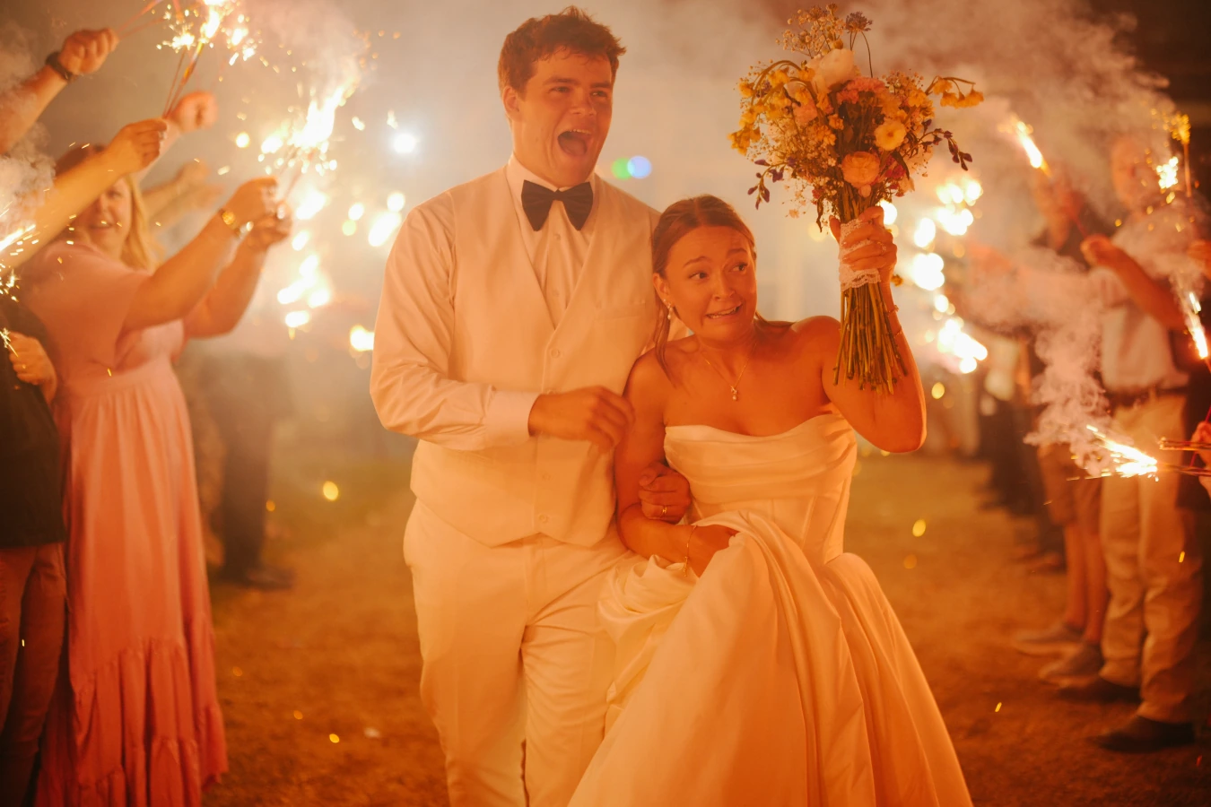 Reception sparkler celebration at Amy and Teddy's North Dakota farm wedding by Megaset Weddings