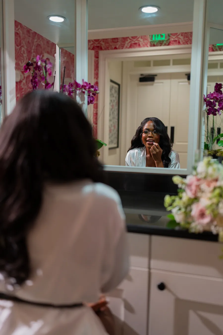 Belinda looking in the mirror while getting ready for her wedding day