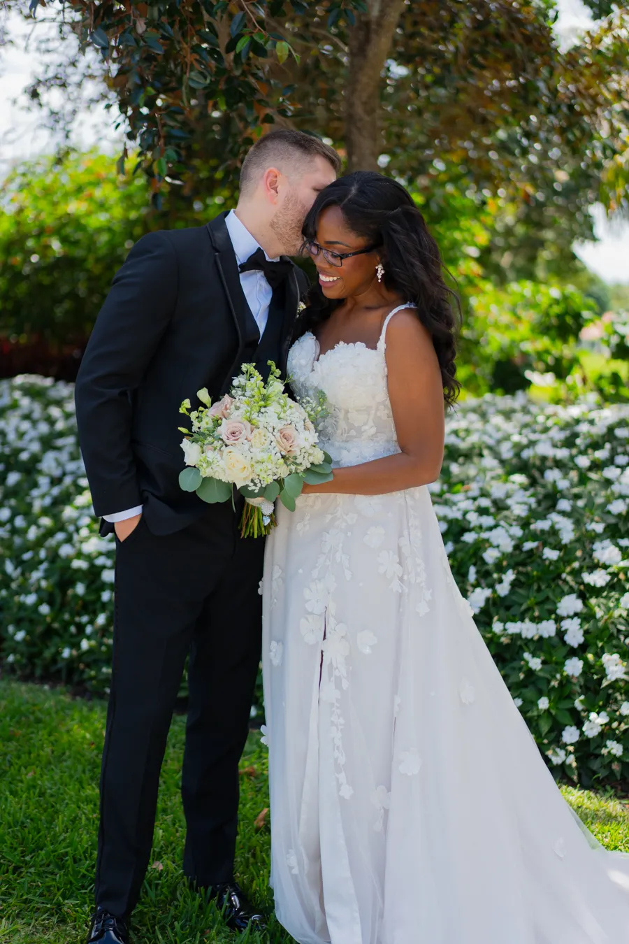 Belinda and Kevin sharing a kiss in the garden after their first look