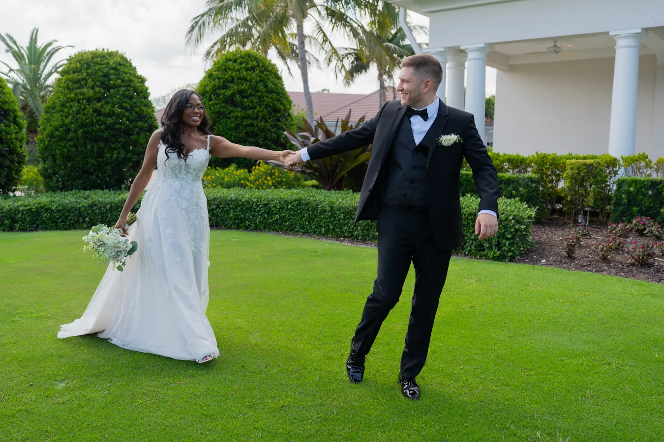 Belinda and Kevin sharing a playful twirl on the lawn