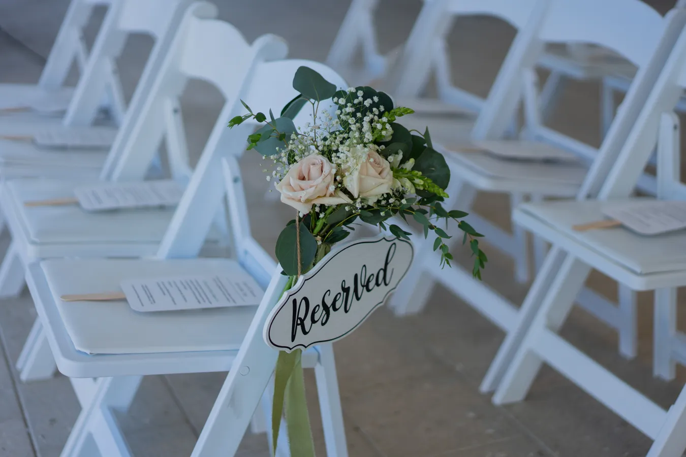 Reserved ceremony chair sign with floral detail