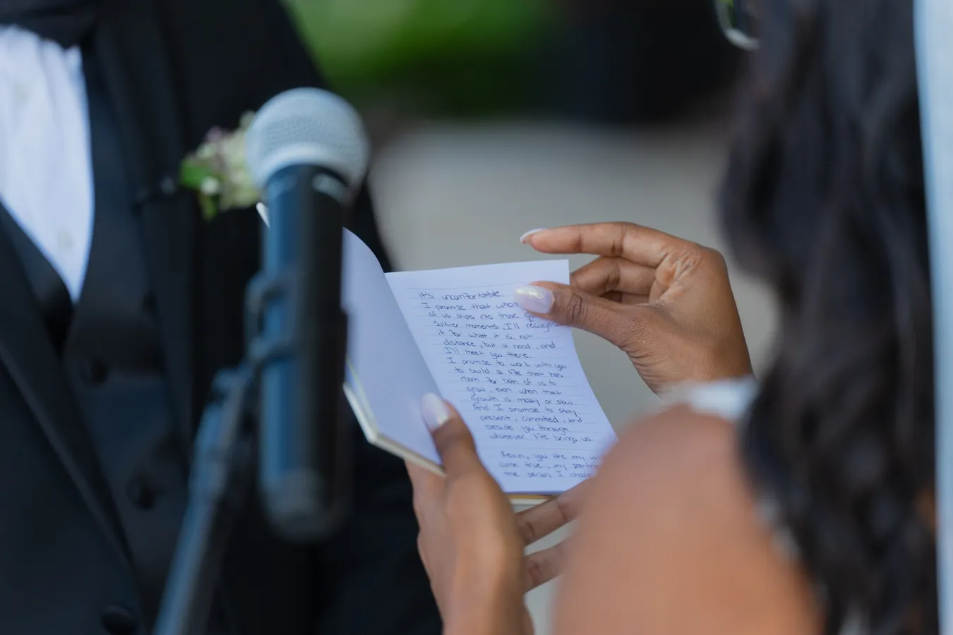 Belinda reading her wedding vows beside the ceremony microphone