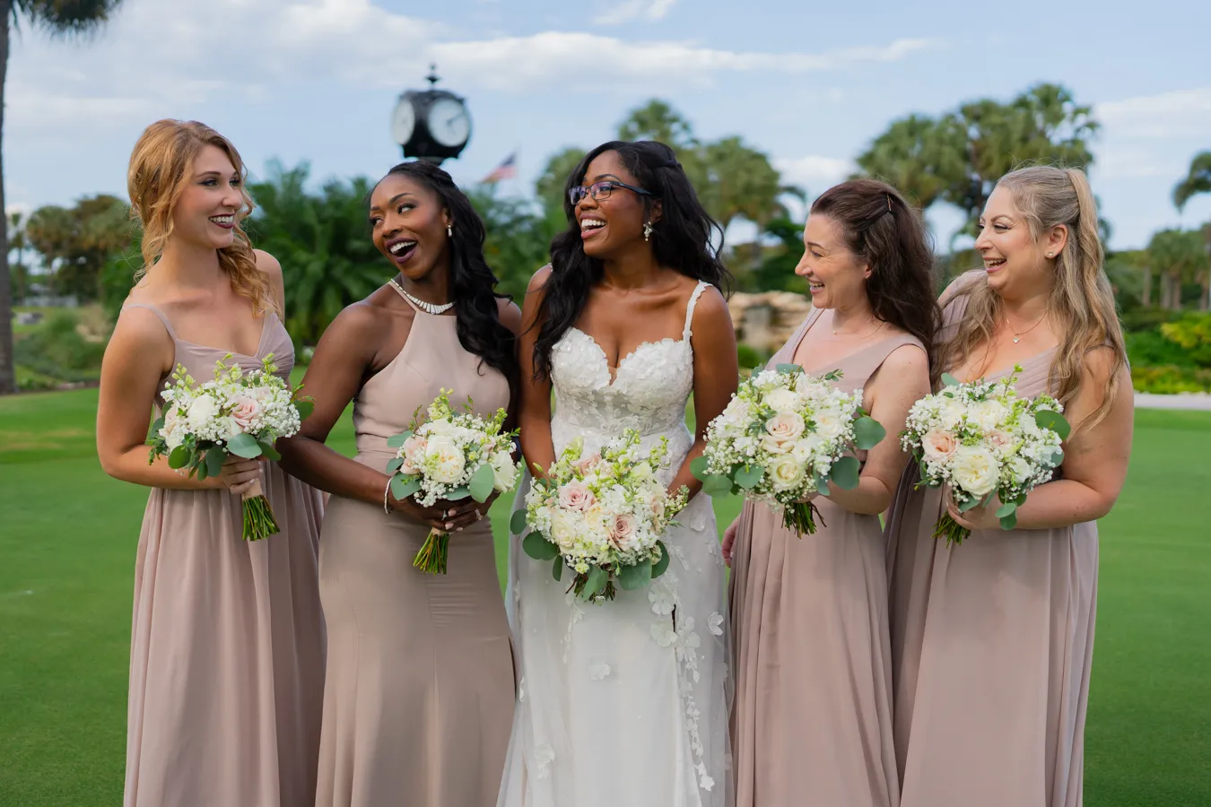 Belinda with her bridesmaids holding soft pastel bouquets