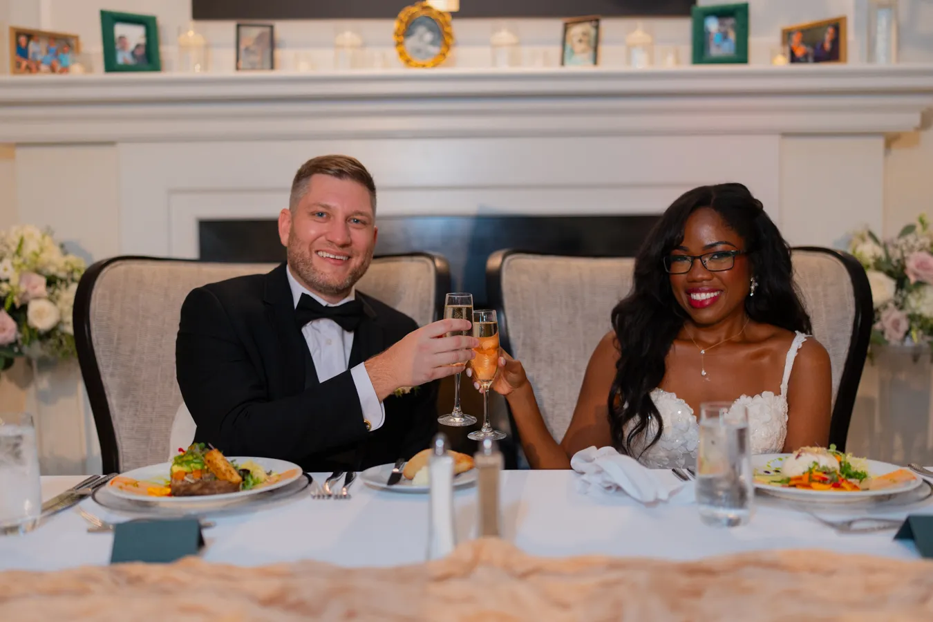 Belinda and Kevin making a toast at their sweetheart table