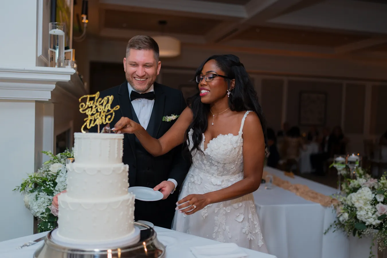 Belinda and Kevin cutting their wedding cake together