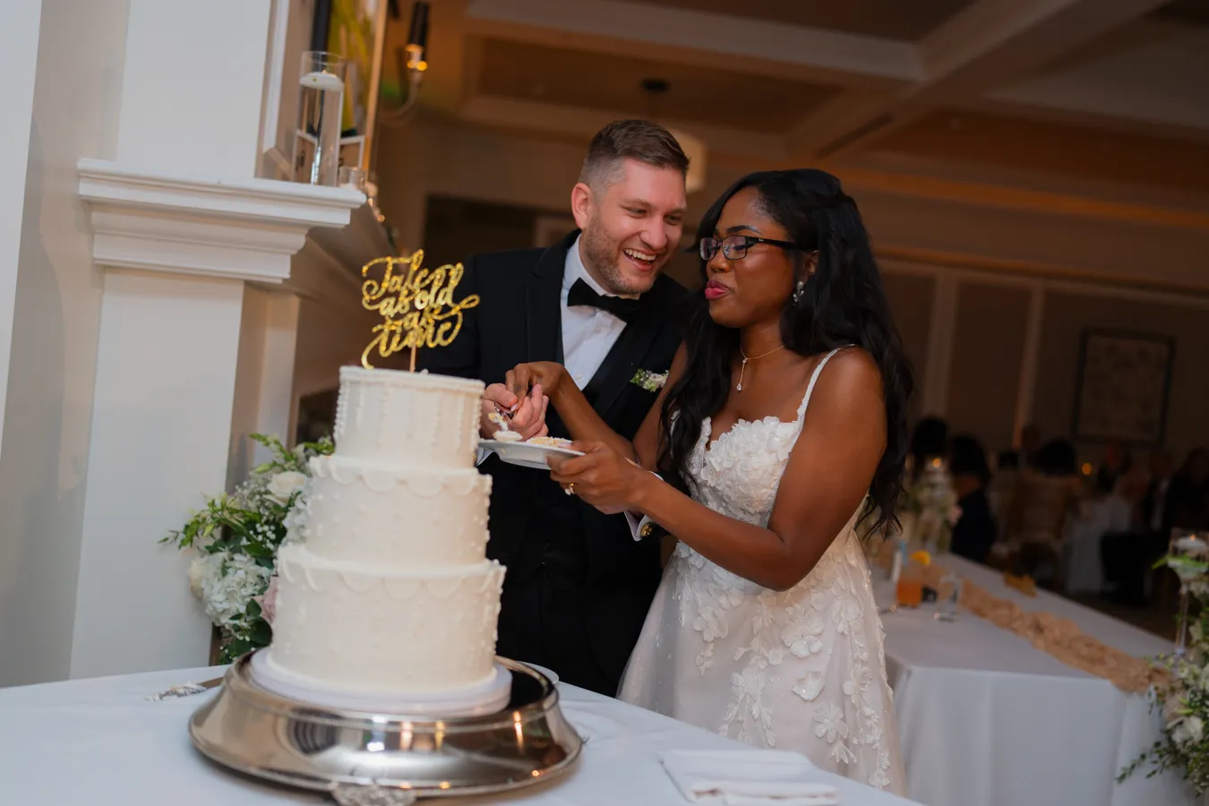 Bride and groom smiling during the cake cutting