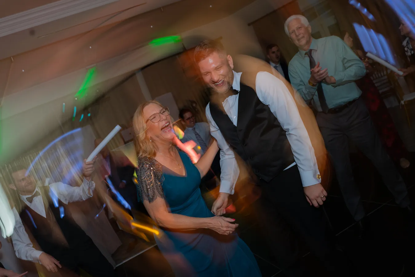 Kevin with his mom dancing with a guest at the reception