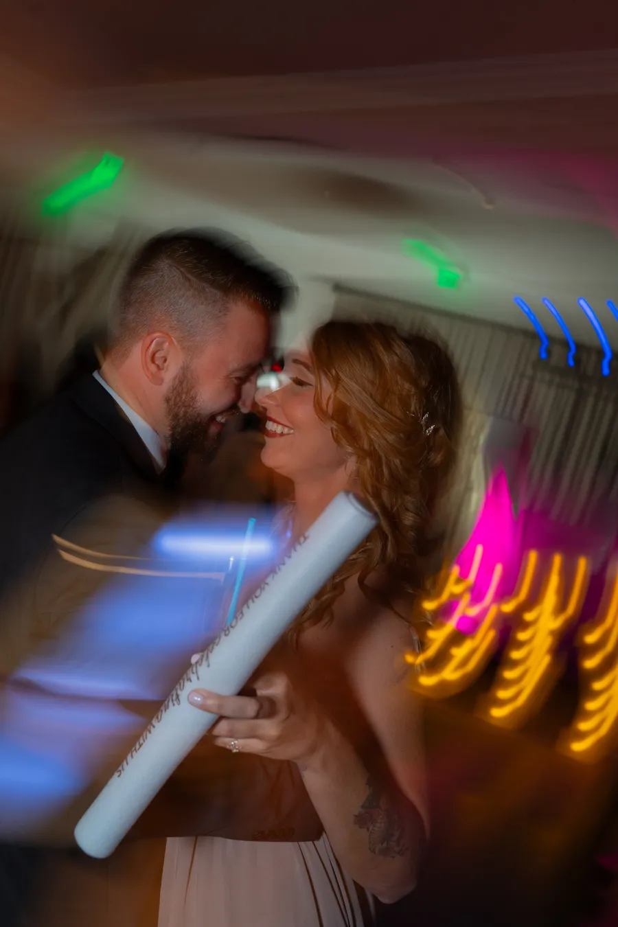 Kevin's sister dancing during the reception with colorful lights