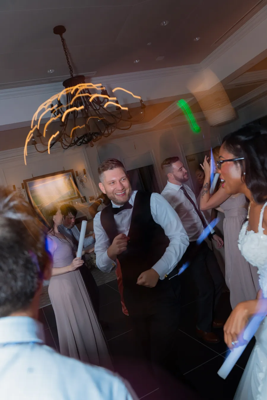 Kevin celebrating on the dance floor with glow sticks