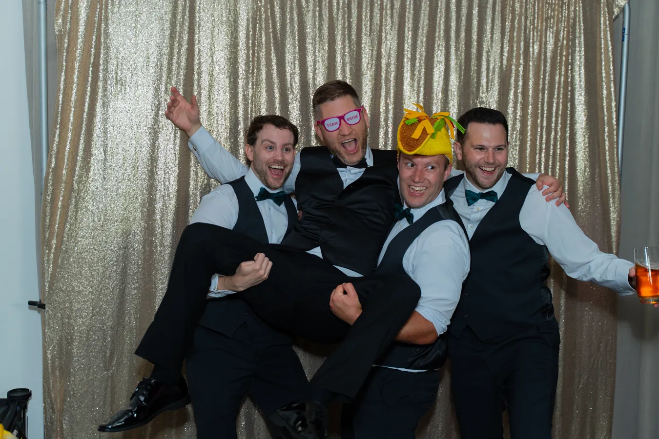 Groomsmen having fun in the photo booth