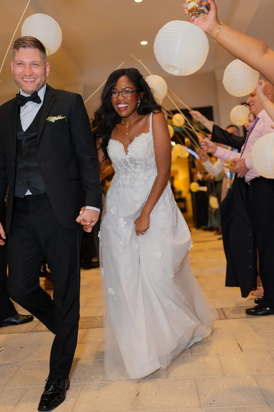 Newlyweds smiling during the reception exit celebration