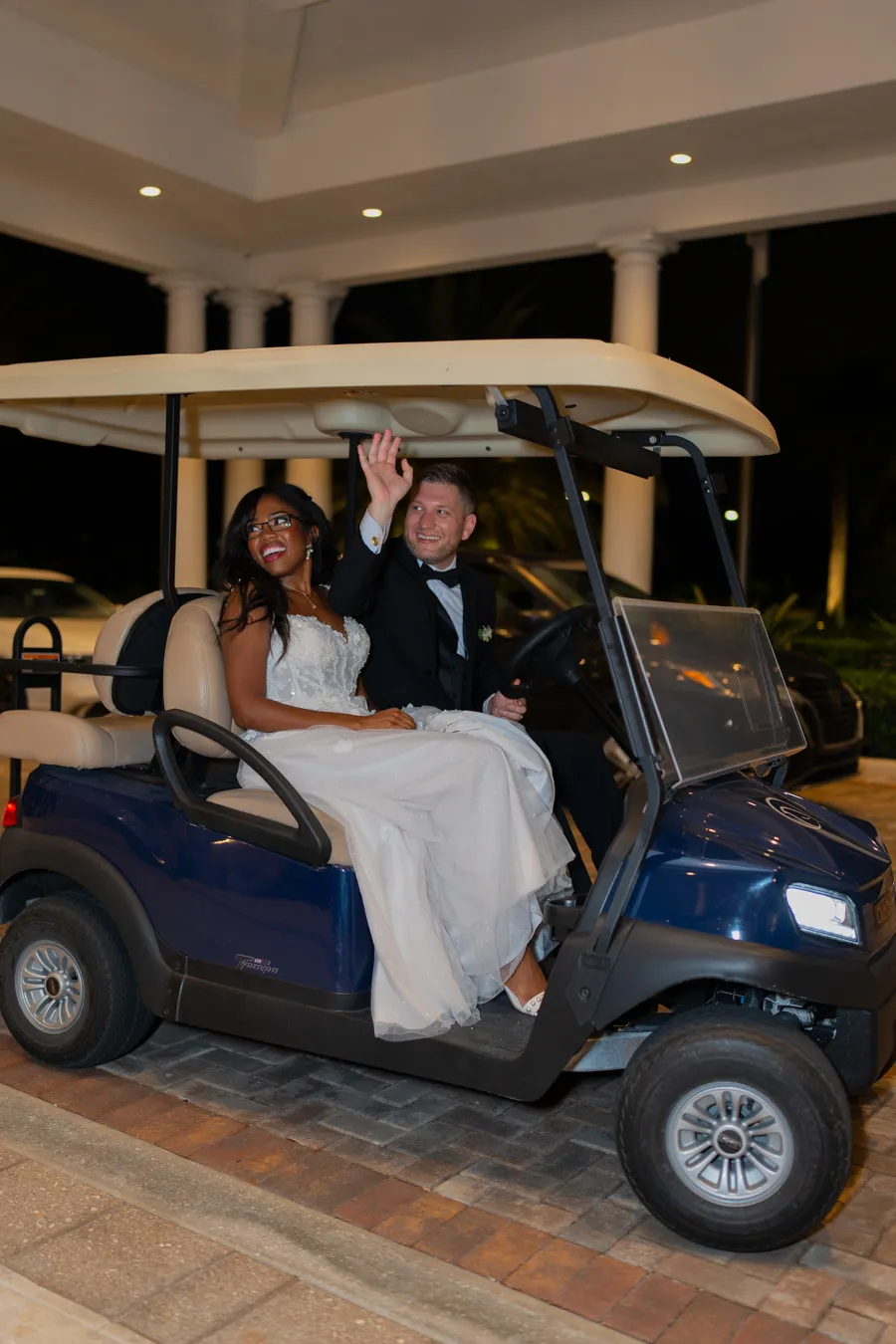 Belinda and Kevin leaving in a golf cart sendoff